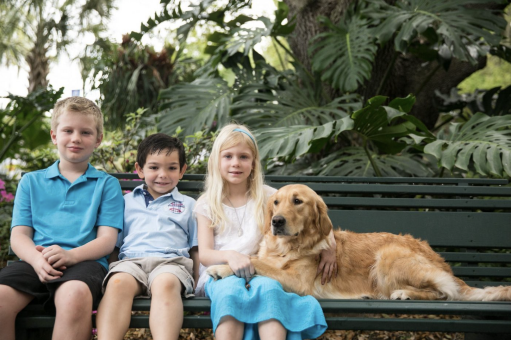 The Martin children sit on a bench with breeder dog Mary.