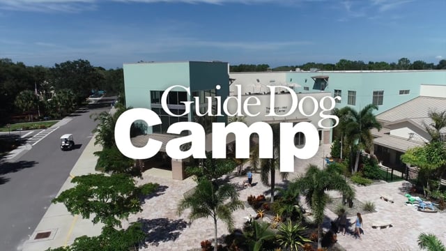 "Guide Dog Camp" over an aerial view of the Southeastern Guide Dog campus.