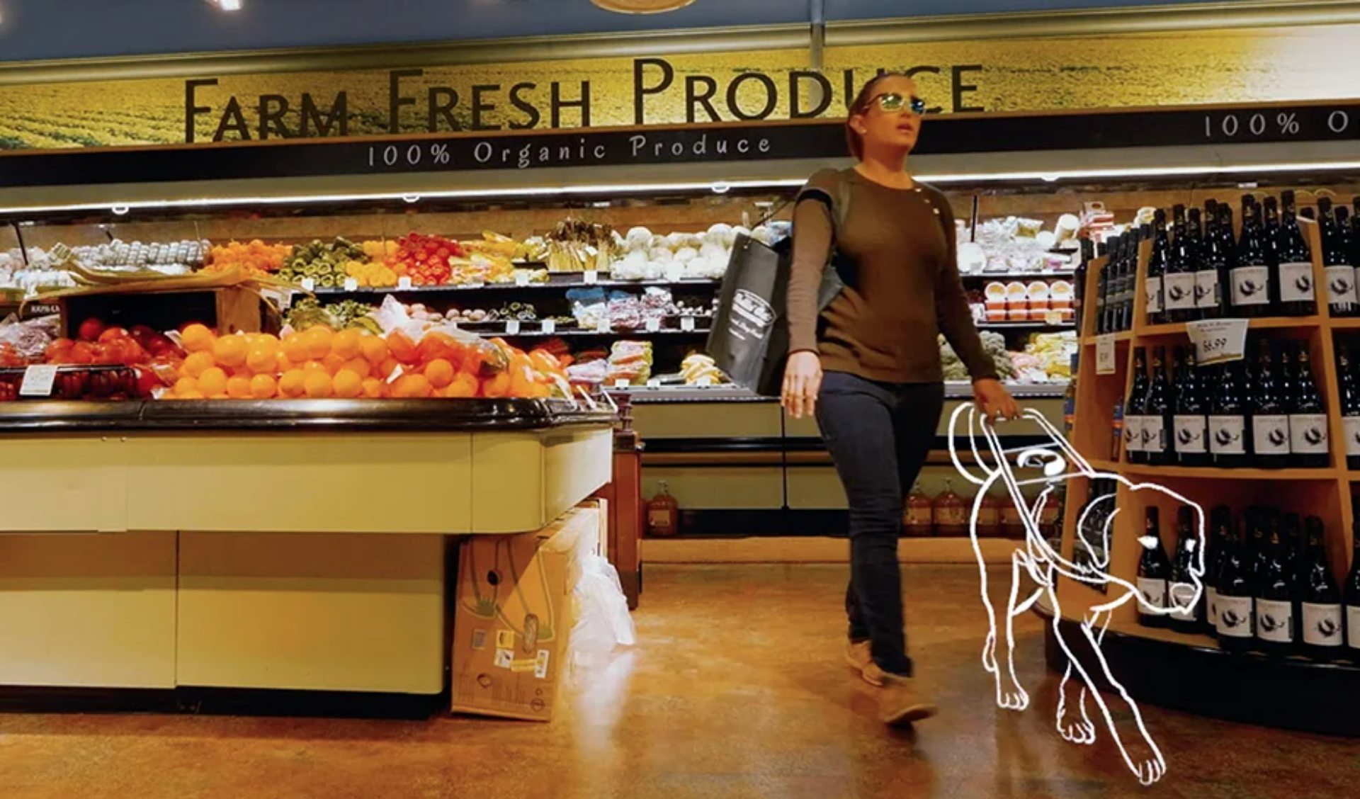 A woman walks through the produce department with a cartoon guide dog guiding her