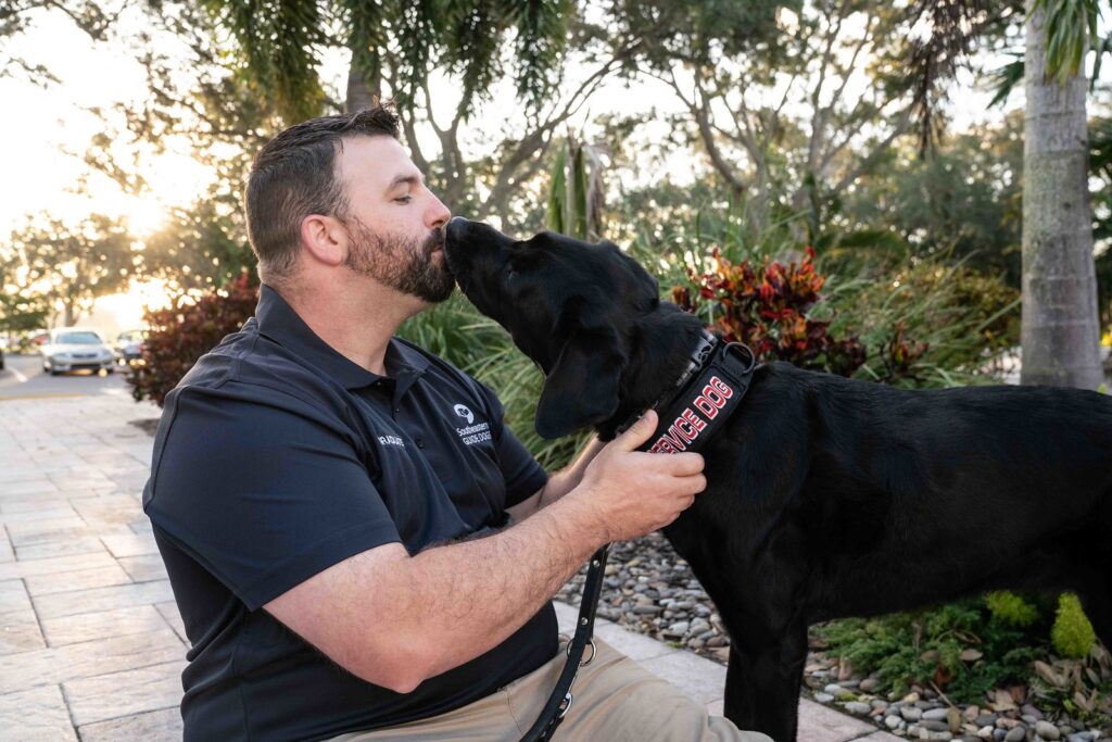 A photo of Travis Johnson with Service Dog Sadie
