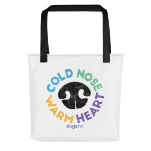 A white tote bag with a black nose print graphic and 'Cold Nose Warm Heart' text in blue, green, yellow, and purple.