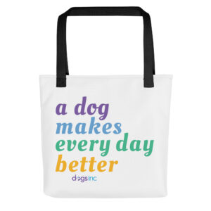 A white tote bag with 'A Dog Makes Every Day Better' graphic text in purple, blue, green, and yellow.