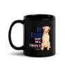 A black coffee mug with a dog graphic and 'In Dogs We Trust' text in red, white, and blue.