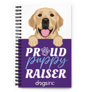 A spiral notebook with a dog graphic and 'Proud Puppy Raiser' text in a purple box.