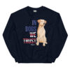 A navy crewneck with a dog graphic and 'In Dogs We Trust' text in red, white, and blue.