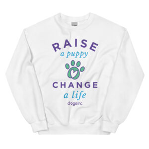 A white crewneck with a graphic paw print and 'Raise a Puppy Change a Life' text in purple and blue.