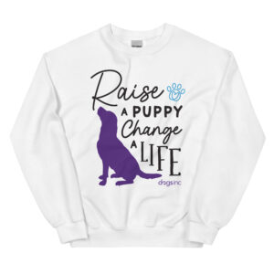 A white crewneck with a dog graphic in purple and 'Raise a Puppy Change a Life' text in black.