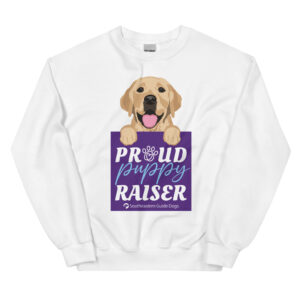 A white crewneck with a dog graphic and 'Proud Puppy Raiser' text in a purple box.
