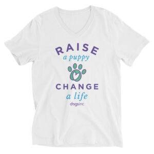 A white v-neck t-shirt with a graphic paw print and 'Raise a Puppy Change a Life' text in purple and blue.
