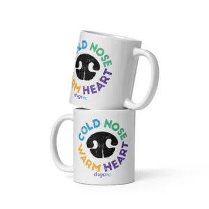 A white coffee mug with a black nose print graphic and 'Cold Nose Warm Heart' text in blue, green, yellow, and purple.