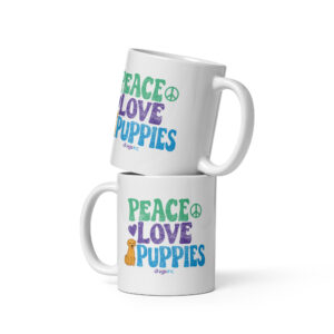 A white coffee mug with a dog graphic and 'Peace Love Puppies' text in green, purple, and blue.