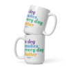 A white coffee mug with 'A Dog Makes Every Day Better' graphic text in purple, blue, green, and yellow.