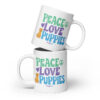 A white coffee mug with a dog graphic and 'Peace Love Puppies' text in green, purple, and blue.