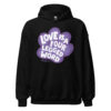 A black sweatshirt with 'Love is a Four Legged Word' text inside a purple paw print graphic.
