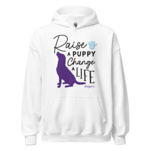 A white sweatshirt with a dog graphic in purple and 'Raise a Puppy Change a Life' text in black.