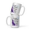 A white coffee mug with a dog graphic in purple and 'Raise a Puppy Change a Life' text in black.