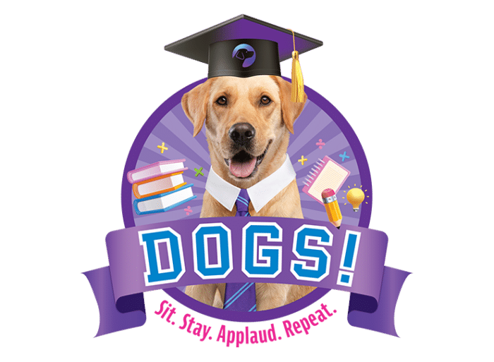 A yellow Labrador wears a purple and blue tie and a black and purple graduation cap. Blue text reads "Dogs!" and underneath, pink text reads "Sit. Stay. Applaud. Repeat."
