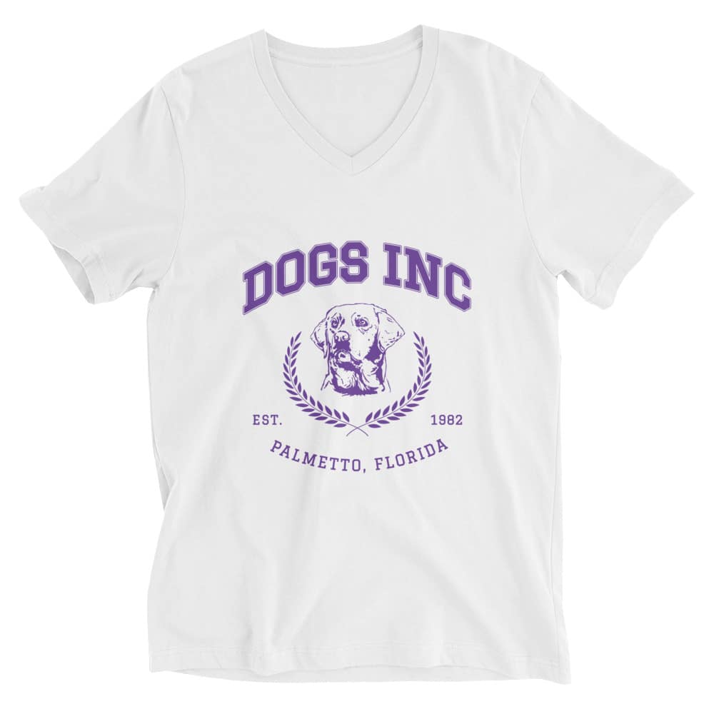 A white v-neck t-shirt with purple font that reads "Dogs Inc Palmetto Florida est. 1982" and an illustration of a Labrador dog in the middle.